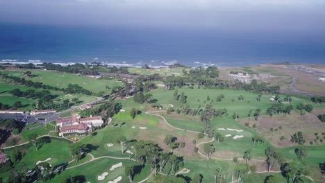 aerial drone footage of fort funston golf grounds and tennis courts with ocean beach in background flying left pan