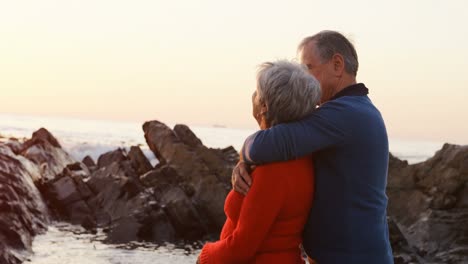 Senior-couple-embracing-on-beach-4k