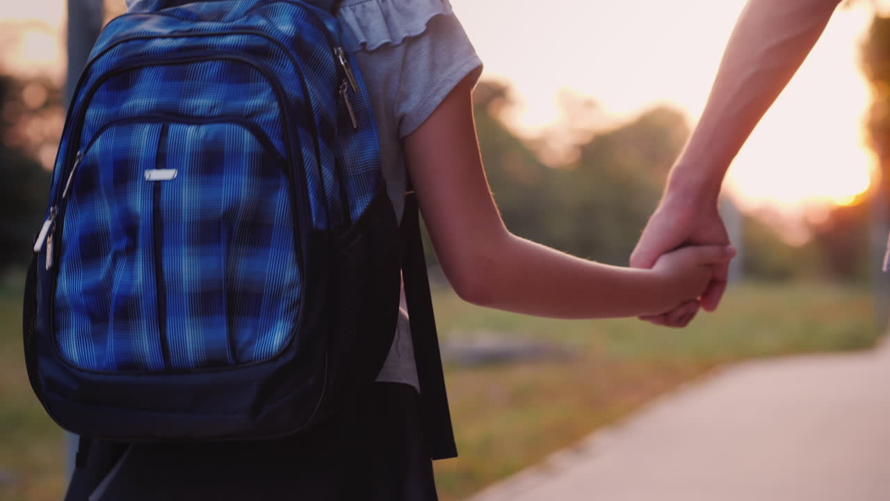 A Young Man Leads His Daughter By The Hand To School