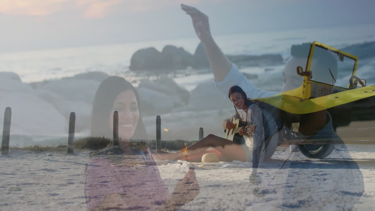 Dancing animation overlaying couple having picnic with guitar on beach