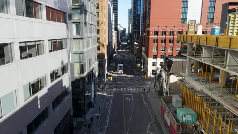 aerial view flying close between office buildings in downtown toronto