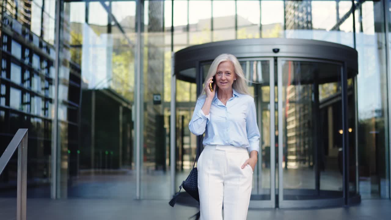 Businesswoman on mobile phone outside office building