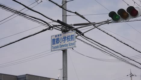 toyosato elementary school sign post and traffic lights, shiga japan