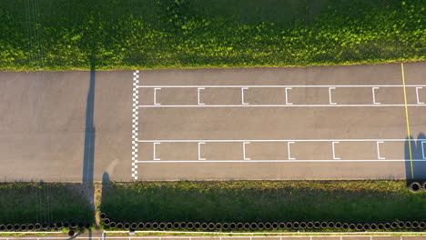 1st place go-kart racer crossing the finish line during golden hour winning race