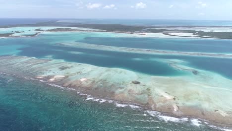 moving back aerial view  beach cay  and-shallow-turquoise waters in the caribbean sea in  sebastopol los-roques national park venezuela.