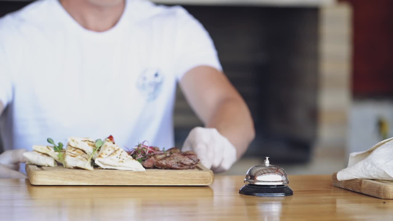 Dish served on plate. Chef finishing plate and almost ready to serve at the table