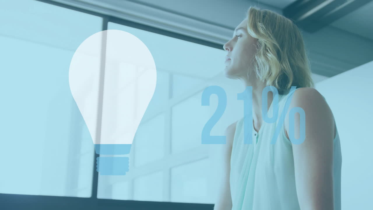Animation of light bulb with growing number over caucasian businesswoman in office