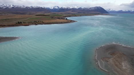 scenic view of lake tekapo with turquoise waters in south island, new zealand. - aerial shot