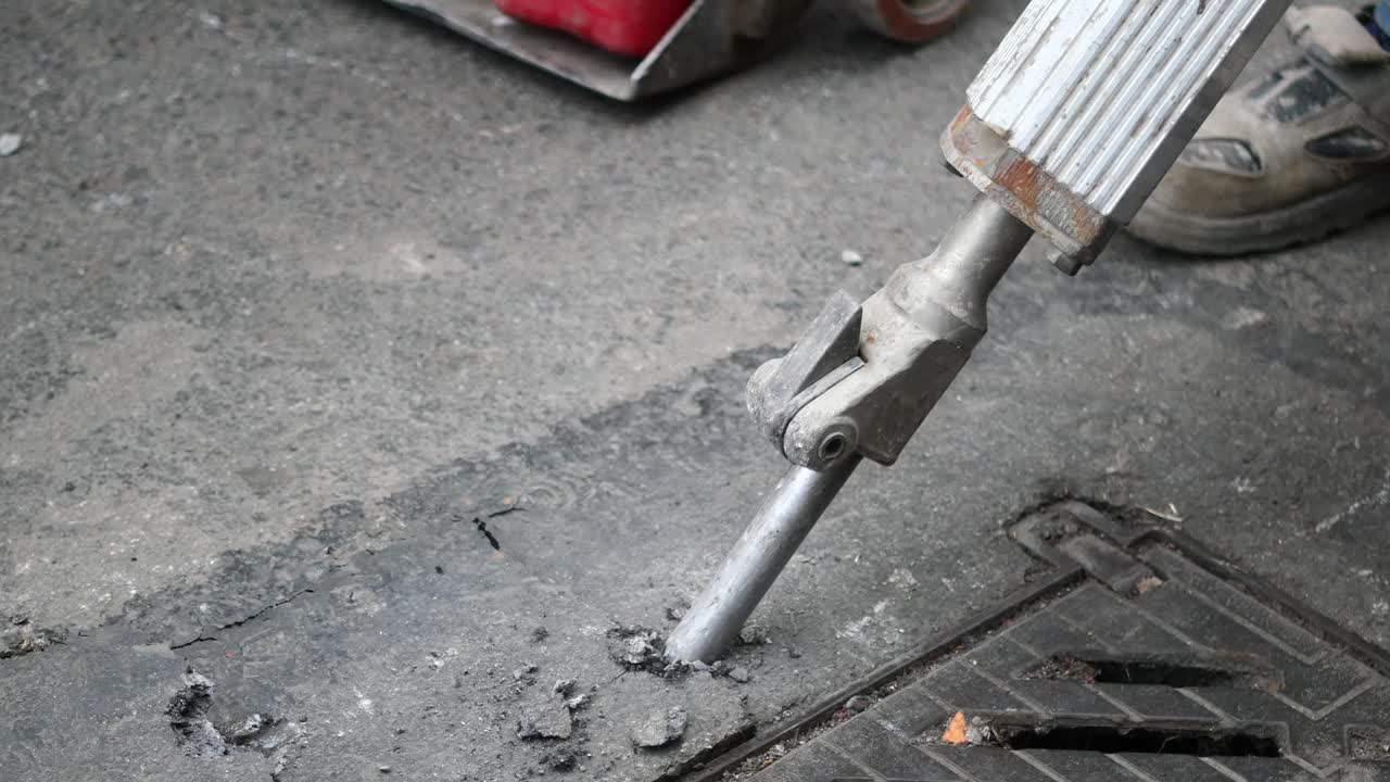 Jackhammer Breaking Pavement