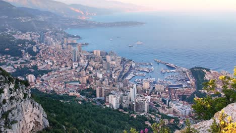 the principality of monaco, viewed from a cliffside overlook in france looking towards monte-carlo, fontvieille and port hercule during the formula 1 monaco grand prix