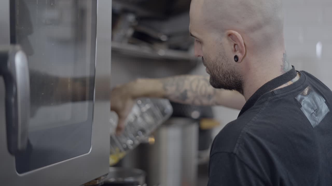 Chef pouring oil into oven