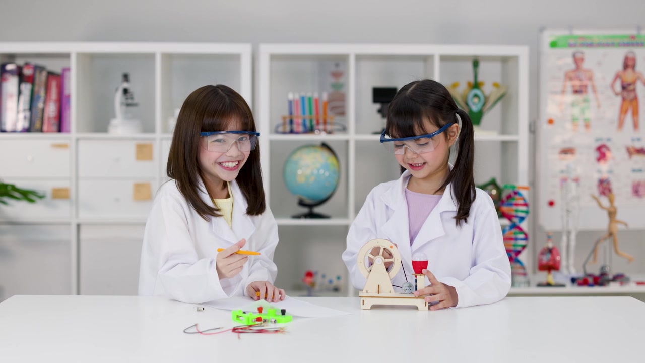 Two Young Girls in Lab Coats Conducting Science Experiments