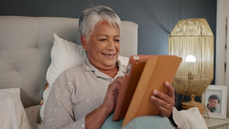 Tablet,-relax-and-senior-woman-in-bed-networking