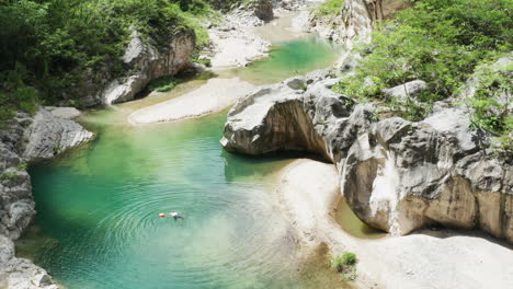 tourist swimming alone in a paradise nizao river, surrounded by wilderness