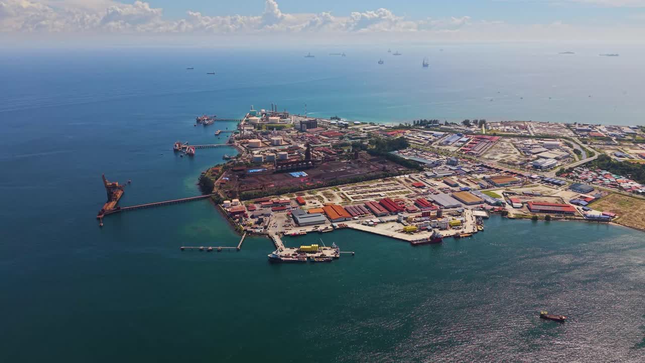 Drone footage of Labuan’s Rancha-Rancha Industrial Estate, Malaysia, featuring Petronas methanol plant, oil and gas facilities, storage tanks, and offshore supply ships in clear tropical waters