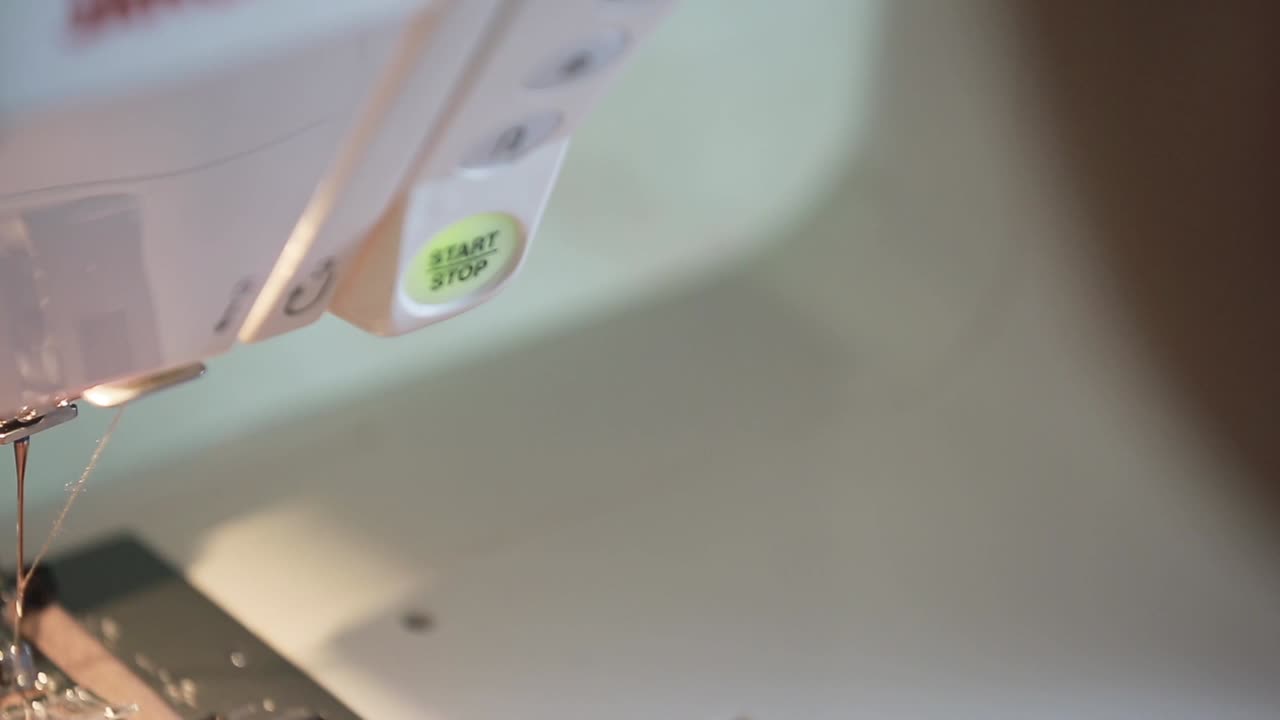 Woman Working on Sewing Machine. Close up of woman adjusting her sewing machine in the process of making clothes