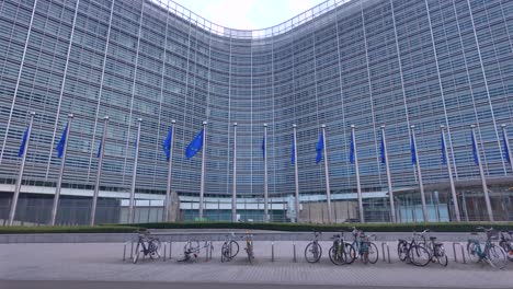 bikes near berlaymont building with eu flags and curved modern facade