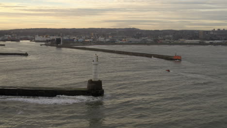 aerial view of a small boat entering aberdeen harbour, aberdeenshire, scotland