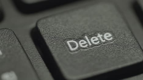 close up of  hand pressing computer keyboard's delete key. germany.