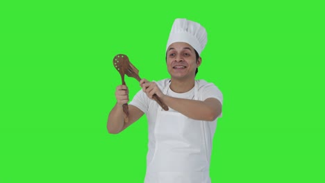 Happy-Indian-professional-chef-dancing-and-enjoying-Green-screen