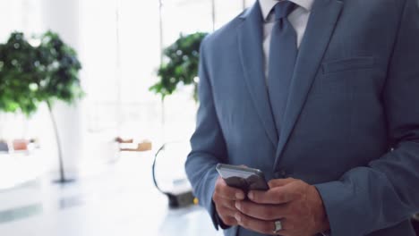 businessman using mobile mobile phone while moving downstairs on escalator i 4k