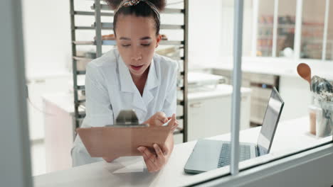 Clipboard,-laptop-and-woman-nurse-in-a-clinic