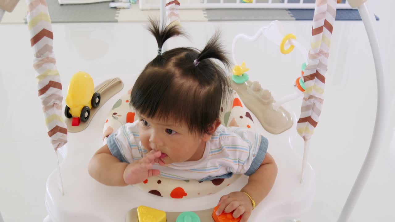 A joyful baby girl experiences playful moments in a caring and vibrant environment.