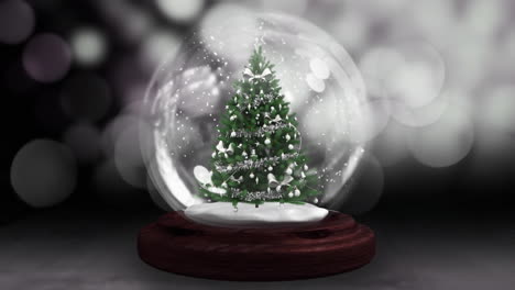 animation of snow globe over winter landscape