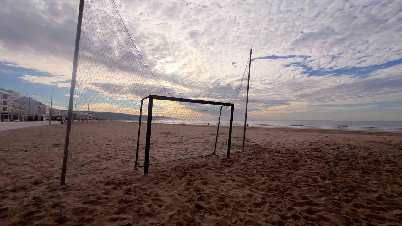 shot from a beach soccer match with the ocean and beach in the background