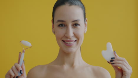 woman using gua sha and facial roller