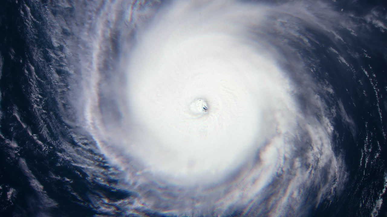 View of Hurricane from Above as Clouds Swirl and Rotate Around Eye of the Storm with the Ocean Below as it Heads Towards Land. Extreme Dangerous Weather. ProRes Animation 4K.