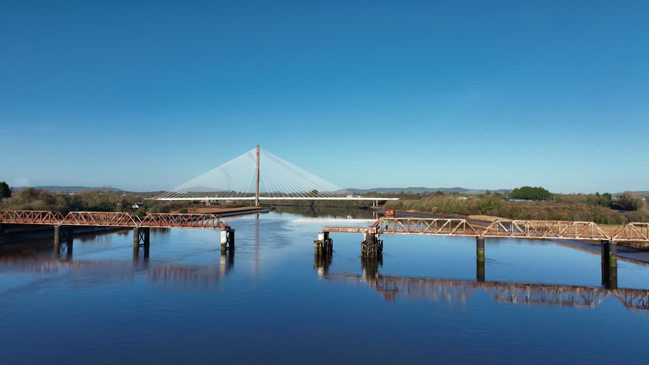 Ireland Locations old and new engineering ruins of old disused railway bridge and modern transport bridge Thomas Francis Meagher Bridge in autumn