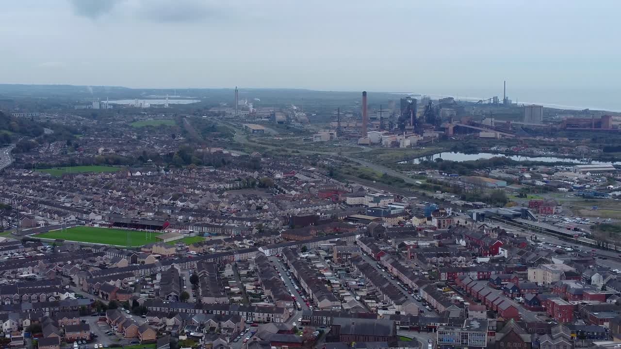 Aerial View Over Welsh Factory Town Port Talbot with Rows of Houses and Rugby Sports Stadium with Steelworks in Background 4K