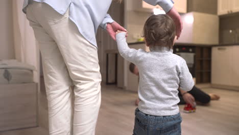 Mother-Helping-Her-Baby-To-Take-The-First-Steps