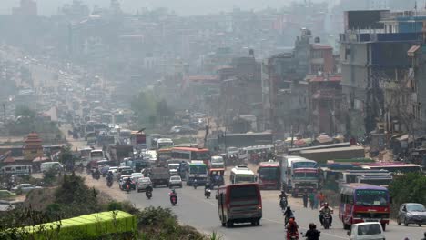 the busy city streets and the heavy pall of smog hanging over the city of kathmandu, nepal