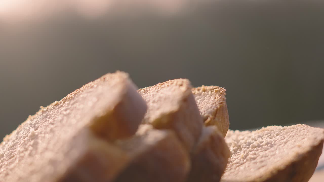 Close Up of Freshly Baked Homemade White Bread Slices Outside in Natural Early Morning Sunlight with Shallow DOF. Home Baking Footage with Simple Healthy Ingredients 4K.