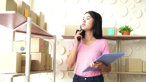 Asian-Women-business-owner-working-at-home-with-packing-box-on-workplace