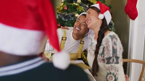 dos amigas diversas celebrando la comida con amigos en tiempo de navidad