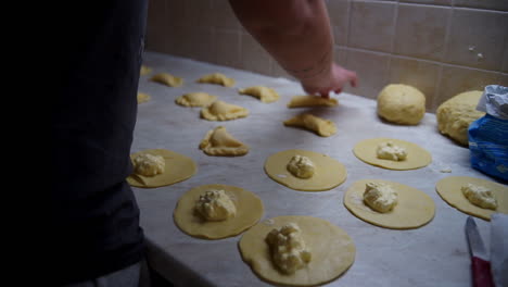 CLOSEUP-footage-of-a-woman-preparing-home-made-greek-cheese-pies