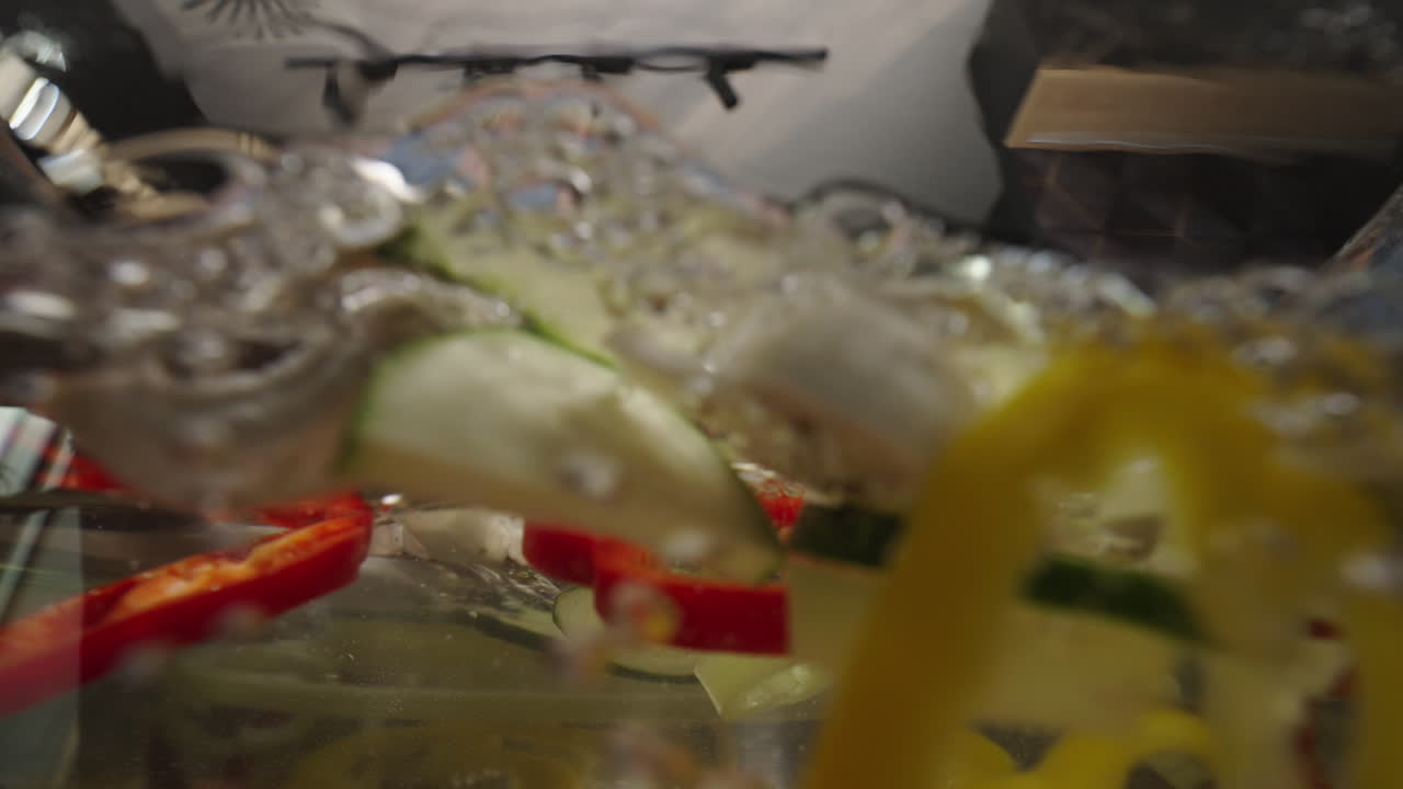 Woman putting vegetables into water