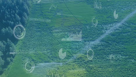 animation of multiple screens with data processing against aerial view of grassland