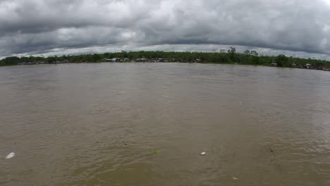 Trash-floating-down-a-large-muddy-river