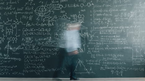 person facing a blackboard with complex equations