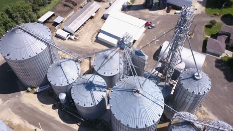 Flying-over-grain-bins-on-farm-during-summer