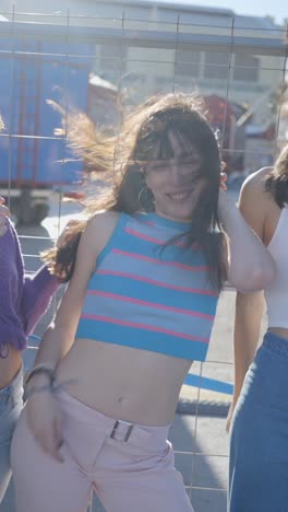 young woman smiling and posing outdoors in a striped crop top