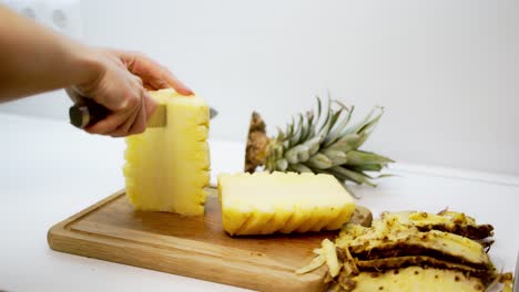pineapple cut with knife. close up view of cut the pineapple with knife