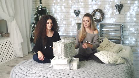 girls with gift box. young smiling beautiful women with gift box in decorated interior