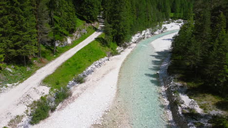 pristine-natural-river-surrounded-by-green-scenery-in-Italian-Dolomites-during-summer,-aerial