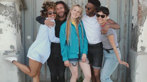 young happy friends posing on street