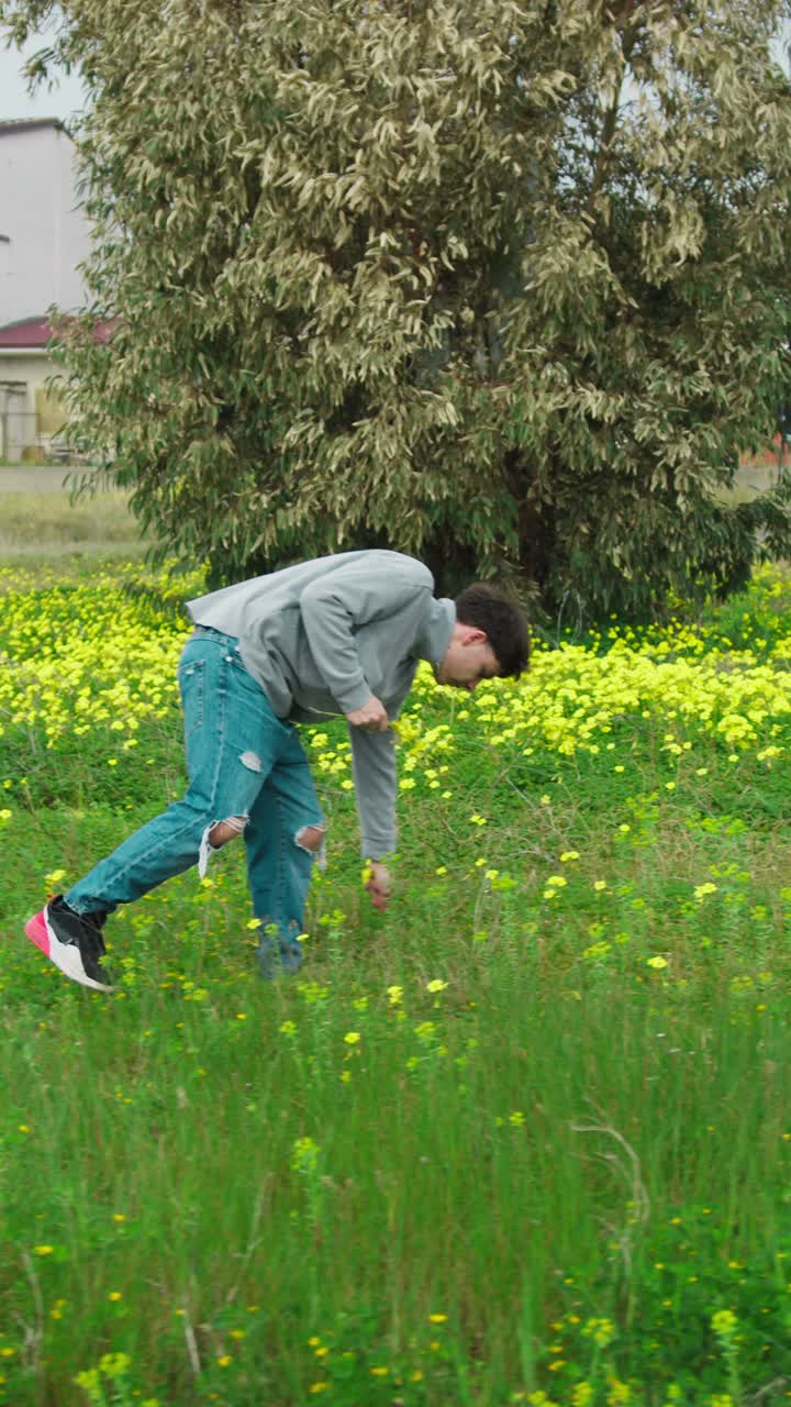 Man In The Green Grass Going Around Picking Up Flowers